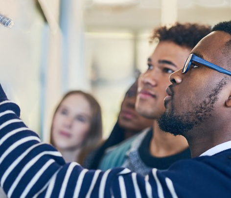 Sparks fly as student uses saw on metal