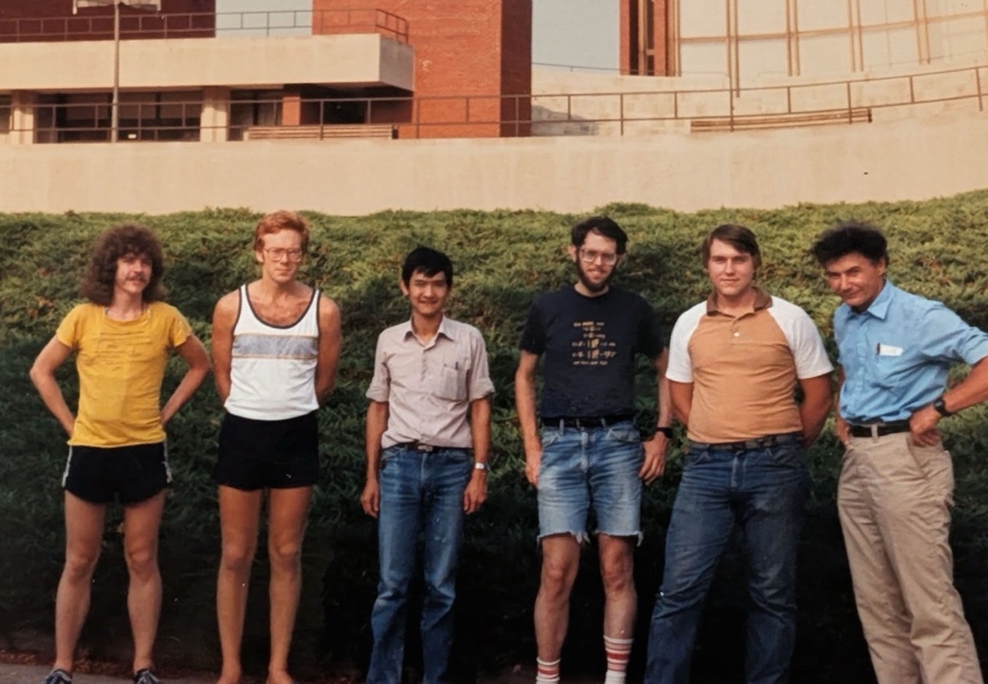 A group of people standing in front of a hedgeAI-generated content may be incorrect.