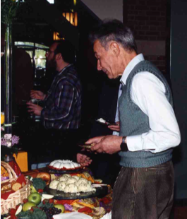 A person standing at a buffet tableAI-generated content may be incorrect.