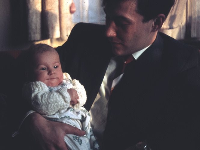 A person holding a babyAI-generated content may be incorrect.