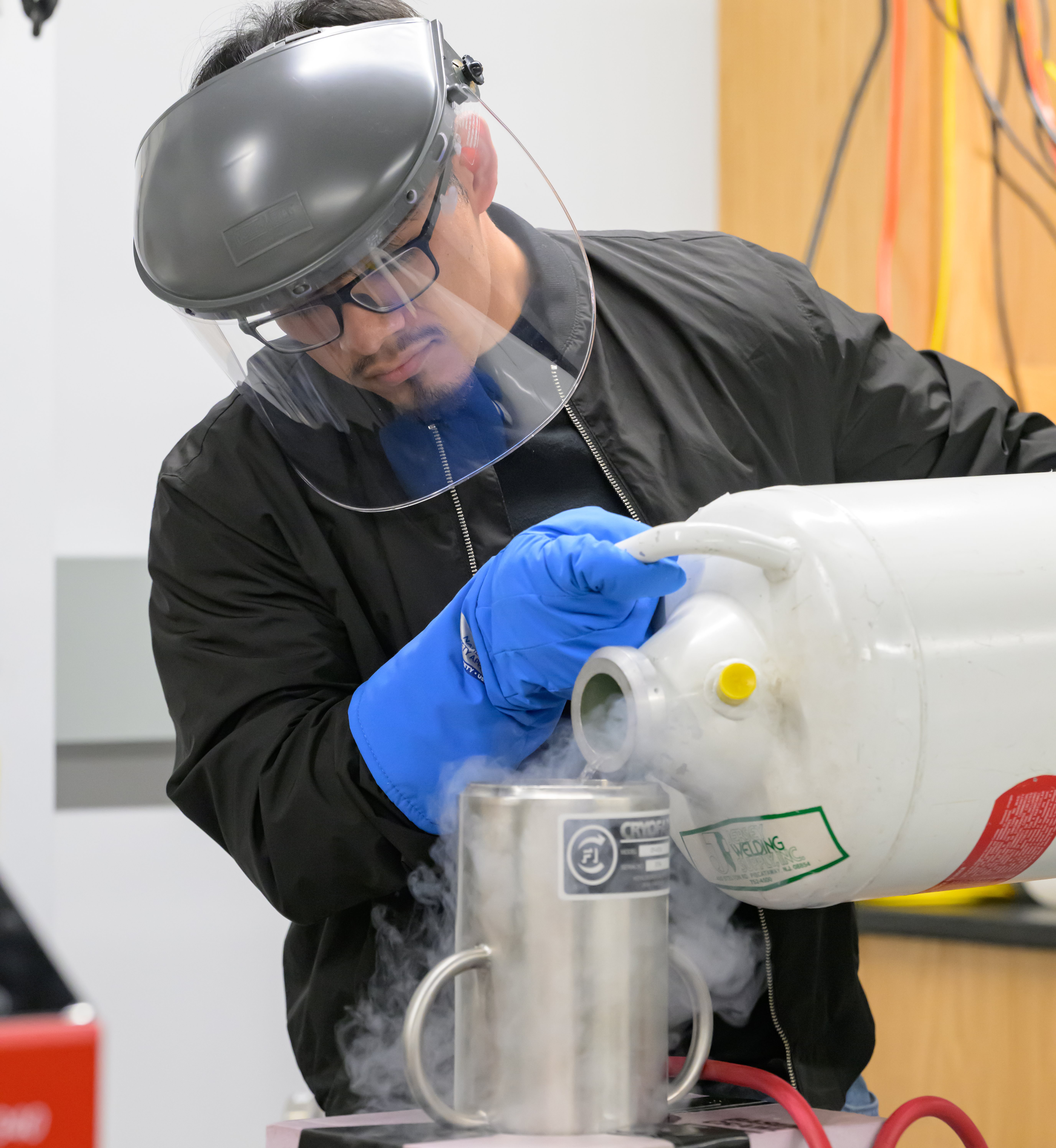 A master's student works with liquid nitrogen