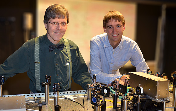 Professor of Physics Paul Kwiat and graduate student Brad Christensen in the lab