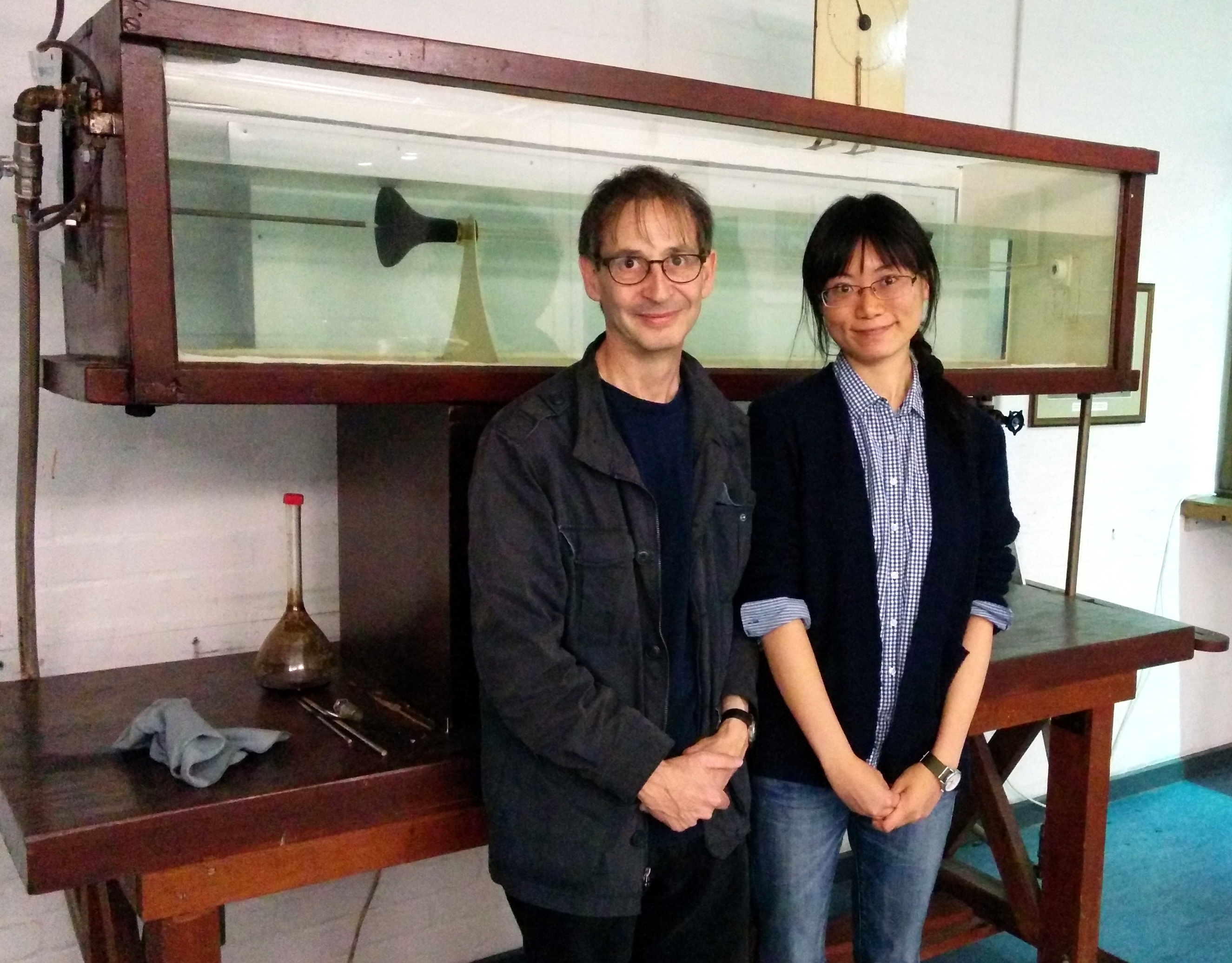 Nigel Goldenfeld and Hong-Yan Shih in front of the original apparatus used by Osborne Reynolds in 1883 to conduct the first scientific studies of the laminar-turbulent transition in pipe flow. Reynolds' apparatus is on display at The University of Manchester, School of Mechanical, Aerospace and Civil Engineering, UK.