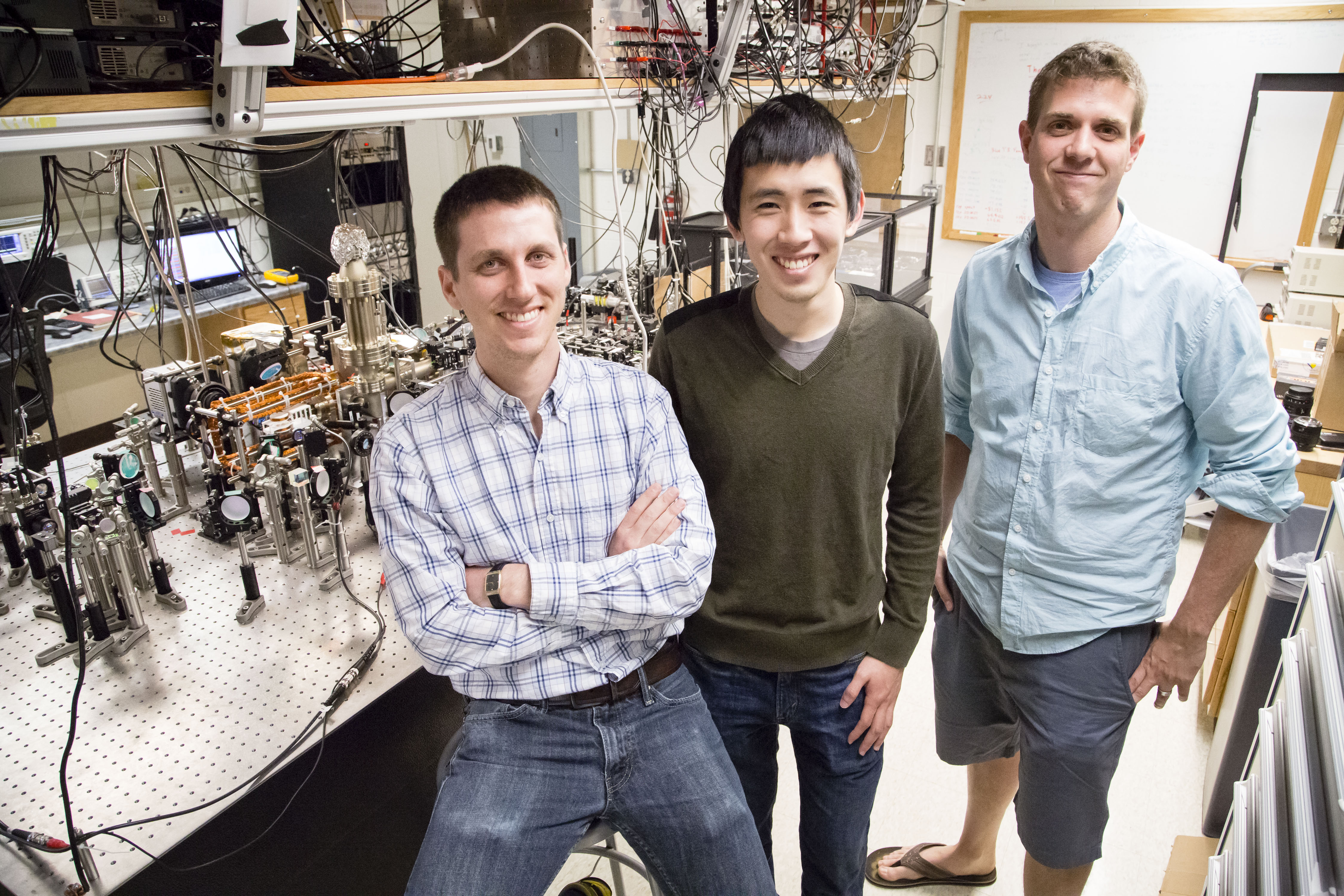 Assistant Professor of Physics Bryce Gadway poses with graduate students Eric Meier (left) and Fangzhao Alex An (center) in his lab, in Loomis Laboratory of Physics, University of Illinois at Urbana-Champaign. Photo credit: L. Brian Stauffer, University of Illinois at Urbana-Champaign