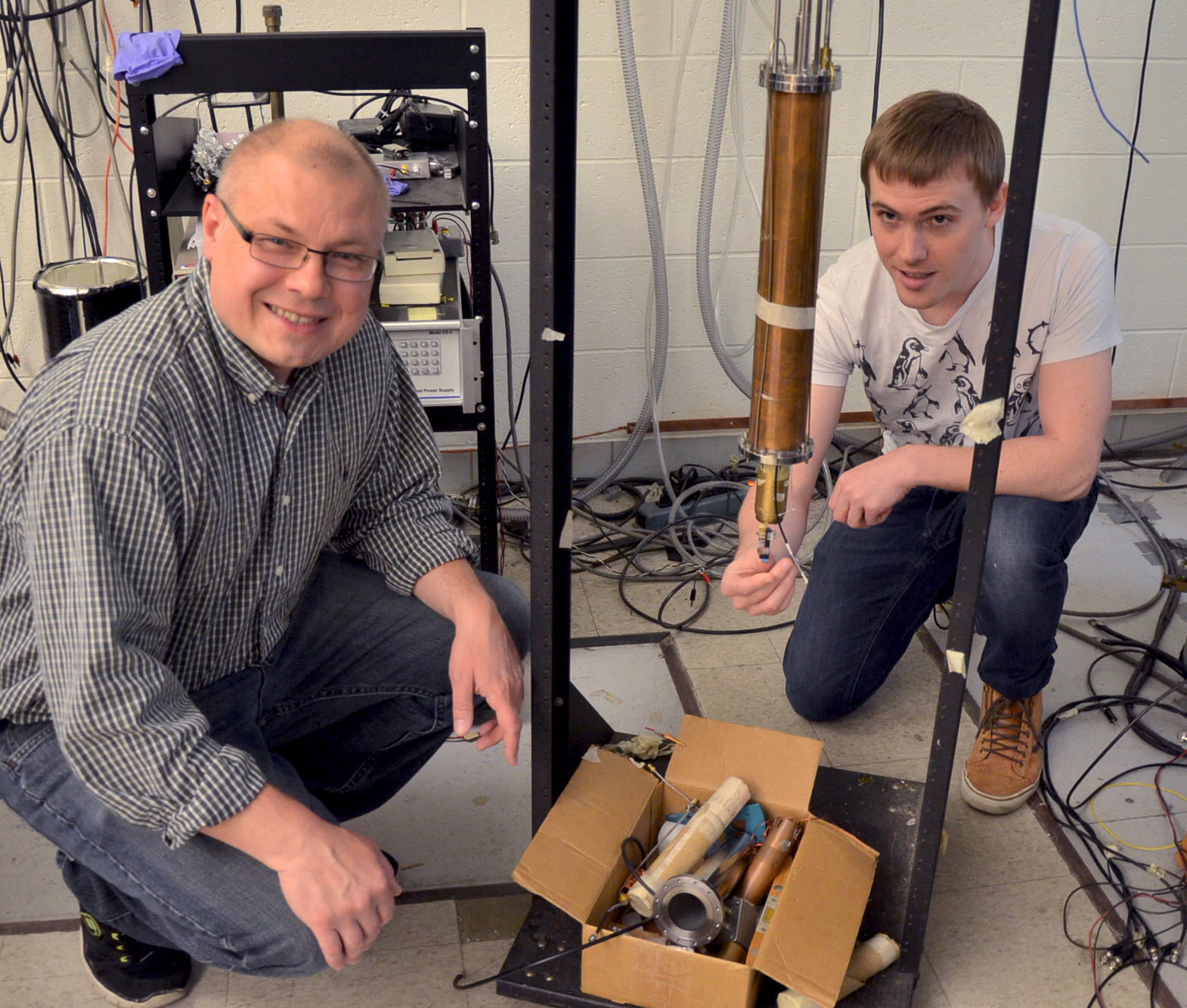 Professor Alexey Bezryadin works in the lab with graduate student Andrew Murphy, at the Loomis Laboratory of Physics in Urbana. Photo by Siv Schwink, Physics Illinois