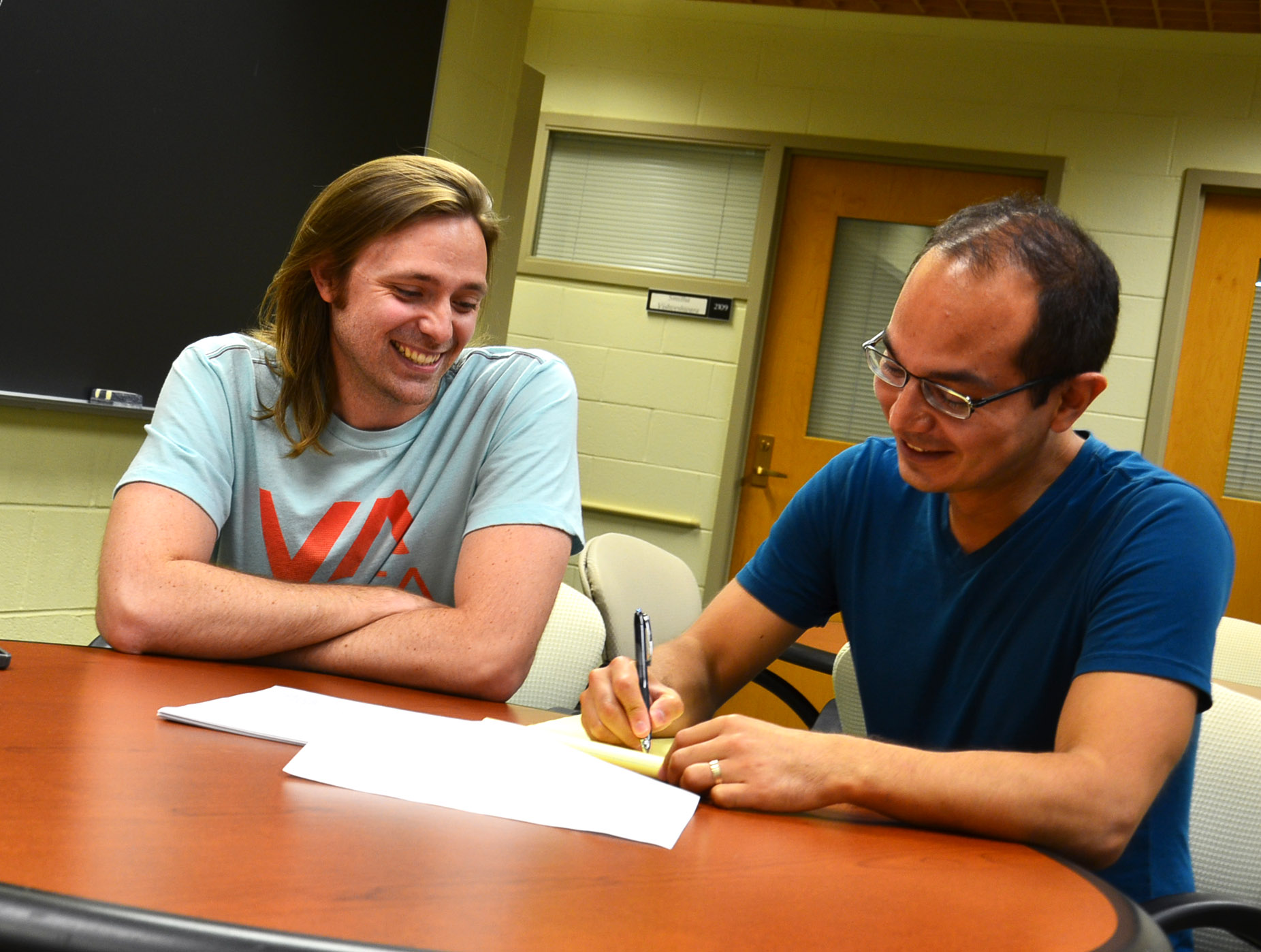 Associate Professor of Physics Taylor Hughes works with graduate student Wladimir Benalcazar at the Institute for Condensed Matter Theory. Photo by Siv Schwink, Department of Physics, University of Illinois at Urbana-Champaign.