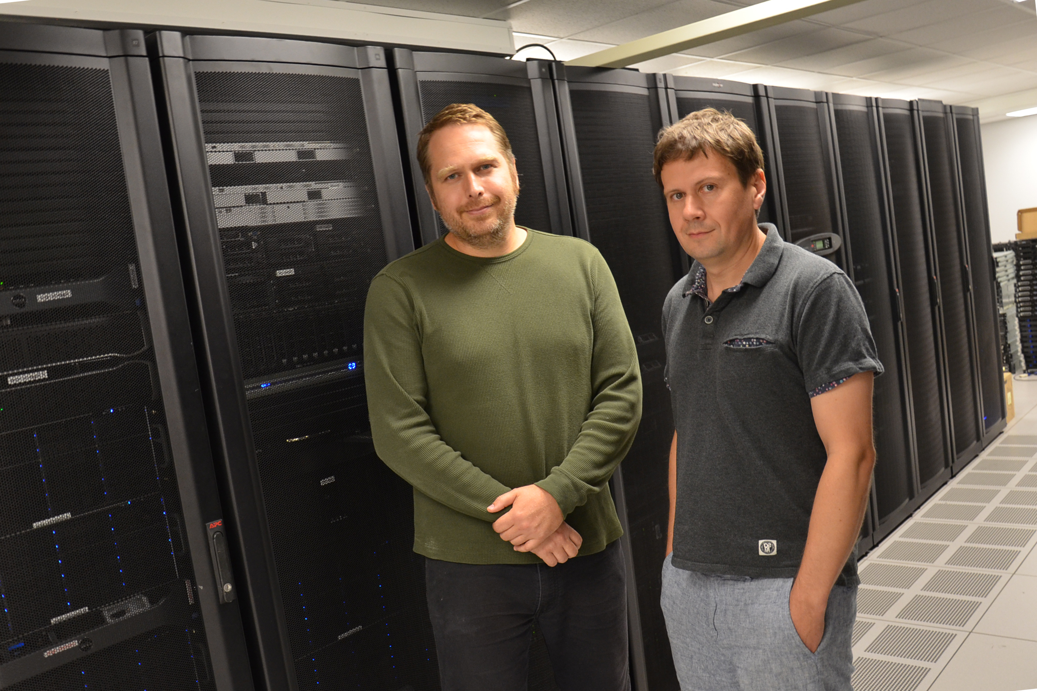 Physics Professor Aleksei Aksimentiev (right) and postdoctoral researcher  James Wilson. Photo by Siv Schwink for Illinois Physics