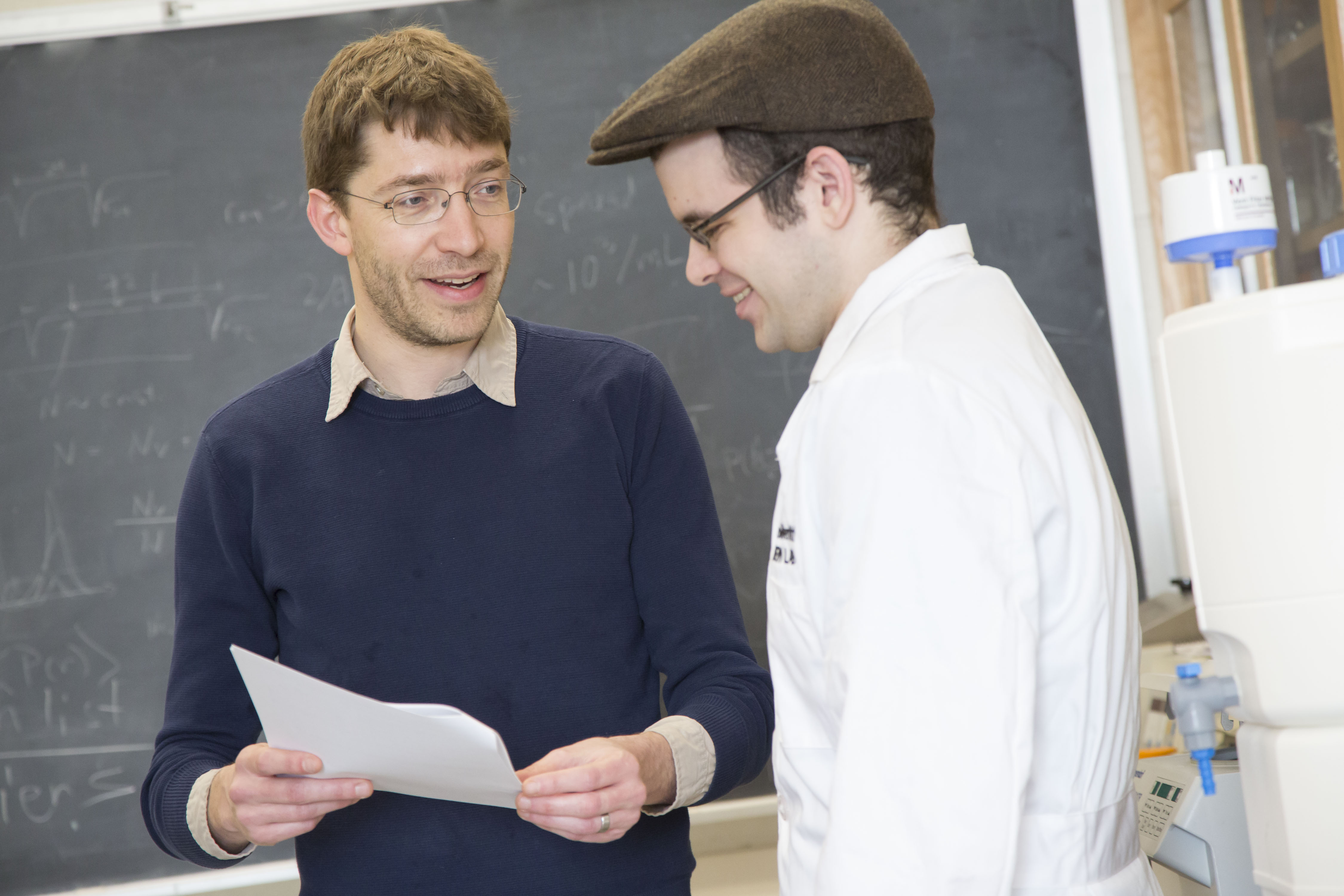 Professor Seppe Kuehn (left) and graduate student Jason Merritt confer in the Loomis Laboratory of Physics in Urbana. Photo by L. Brian Stauffer, University of Illinois at Urbana-Champaign