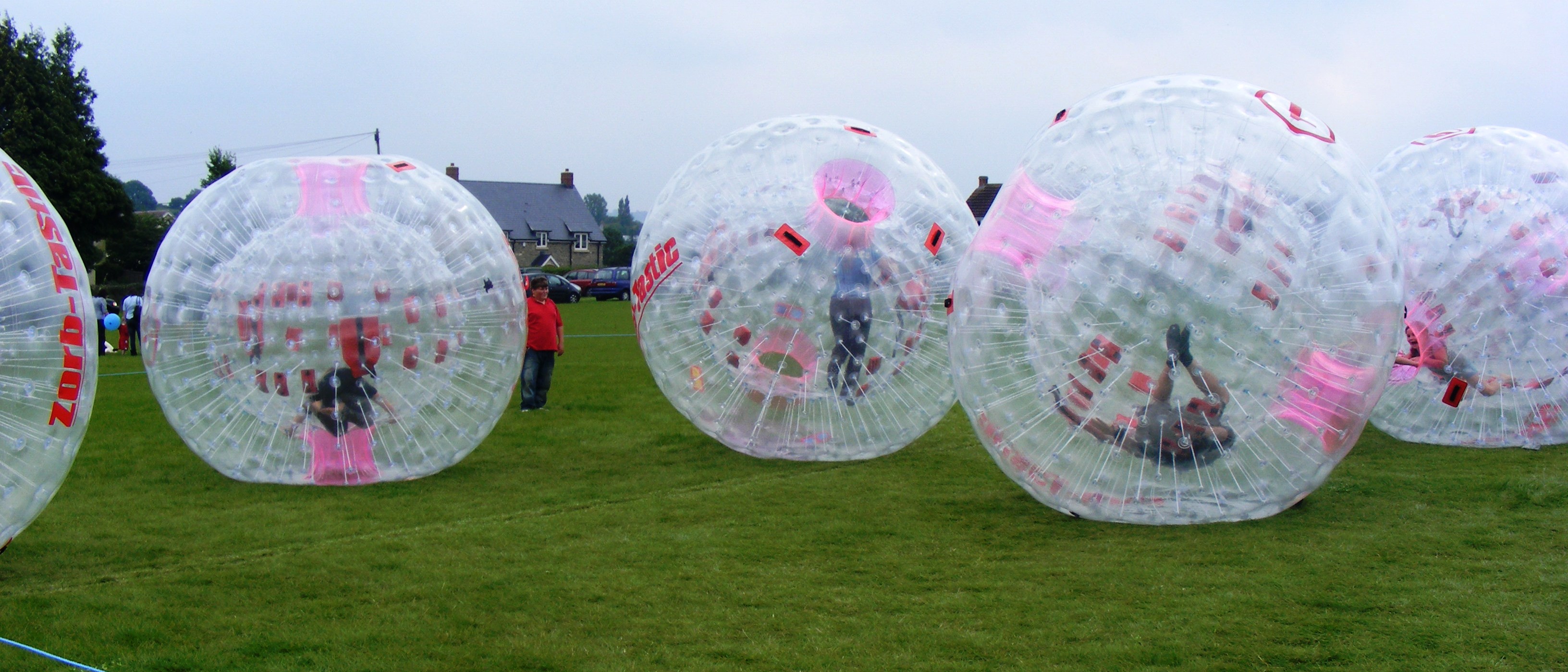 Zorbing, rolling and bouncing in an inflated transparent ball, has become popular around the world. Bikash Padhi, a University of Illinois at Urbana-Champaign graduate student in theoretical condensed matter physics, compares Wigner crystallization to swelling zorbs in a closed field, where the zorb passengers are electrons and the zorb itself is a measure of each electron's repulsion to other electrons. Credit: Username:Rodw/Wikimedia Commons/Public Domain