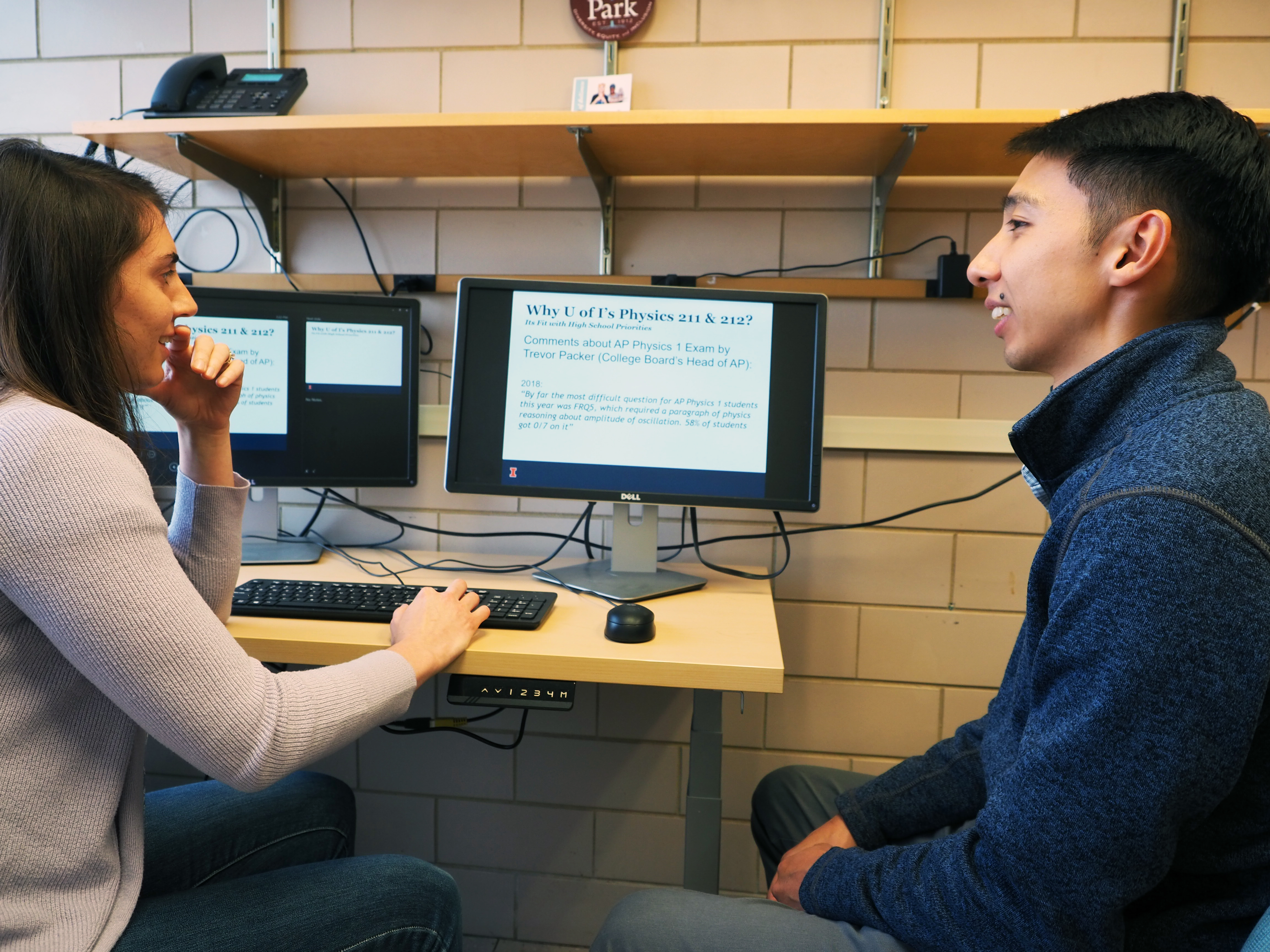 Professor Eric Kuo (right) discusses AP Physics education with Maggie Mahmood.