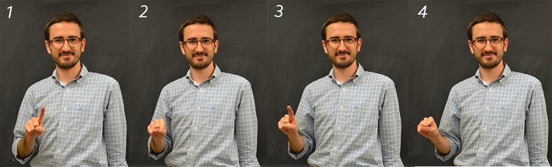 Illinois Physics graduate student Colin Lualdi demonstrates the sign for 'photon,' which evokes its dual wave-particle nature. This is among the newer signs that Deaf physicists have started to adopt.