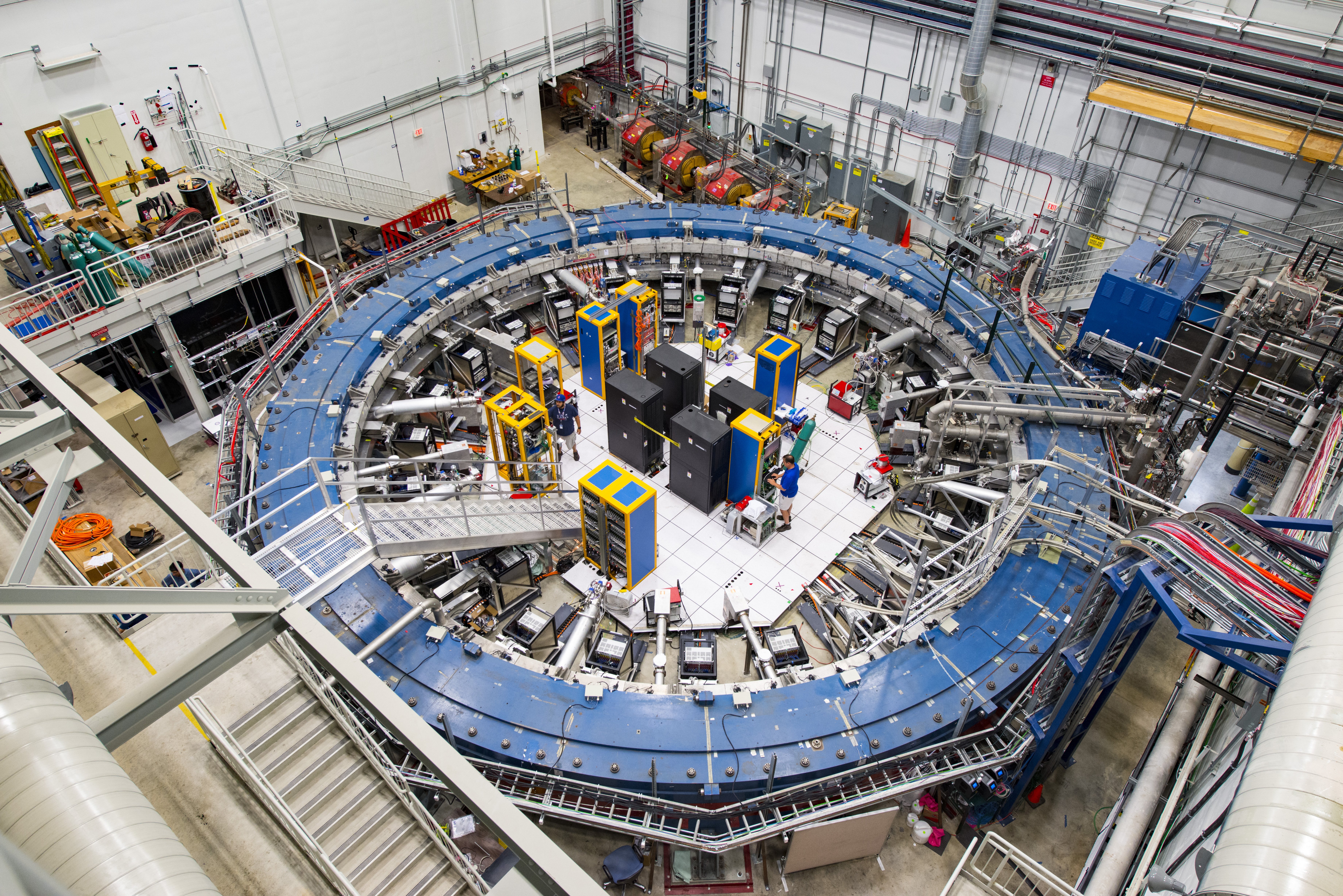 The Muon g-2 ring sits in its detector hall amidst electronics racks, the muon beamline, and other equipment. This impressive experiment operates at negative 450 degrees Fahrenheit and studies the precession (or wobble) of muons as they travel through the magnetic field. Photo by Reidar Hahn/Fermilab