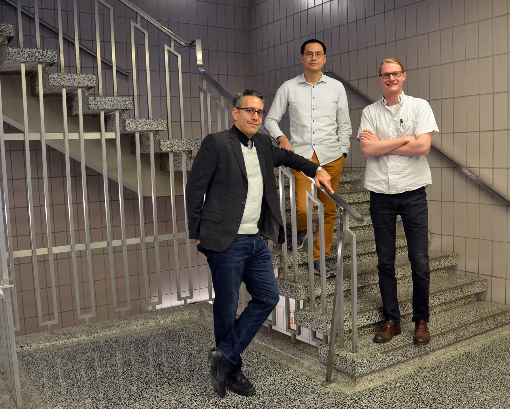 Illinois Physics Professor Nico Yunes (L) poses with with postdoc Hector Silva (middle) and graduate student Scott Perkins in the foyer of Loomis Laboratory of Physics. Photo by Siv Schwink for Illinois Physics