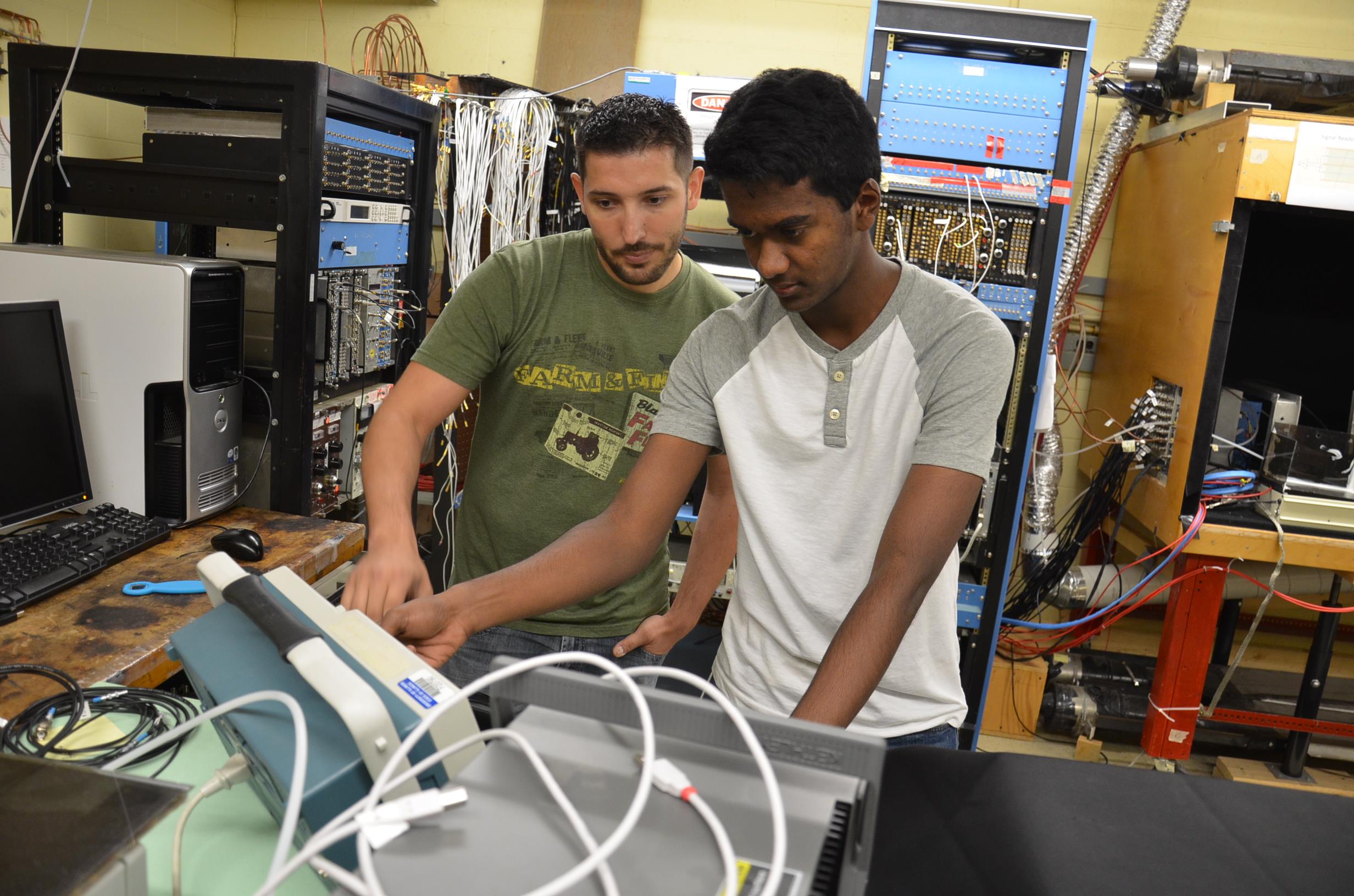 Mentor Chad Lantz and Young Scholar Sibiraj Senguttuvan (right) work on testing an LHC detector in Matthias Grosse Perdekamp's lab.