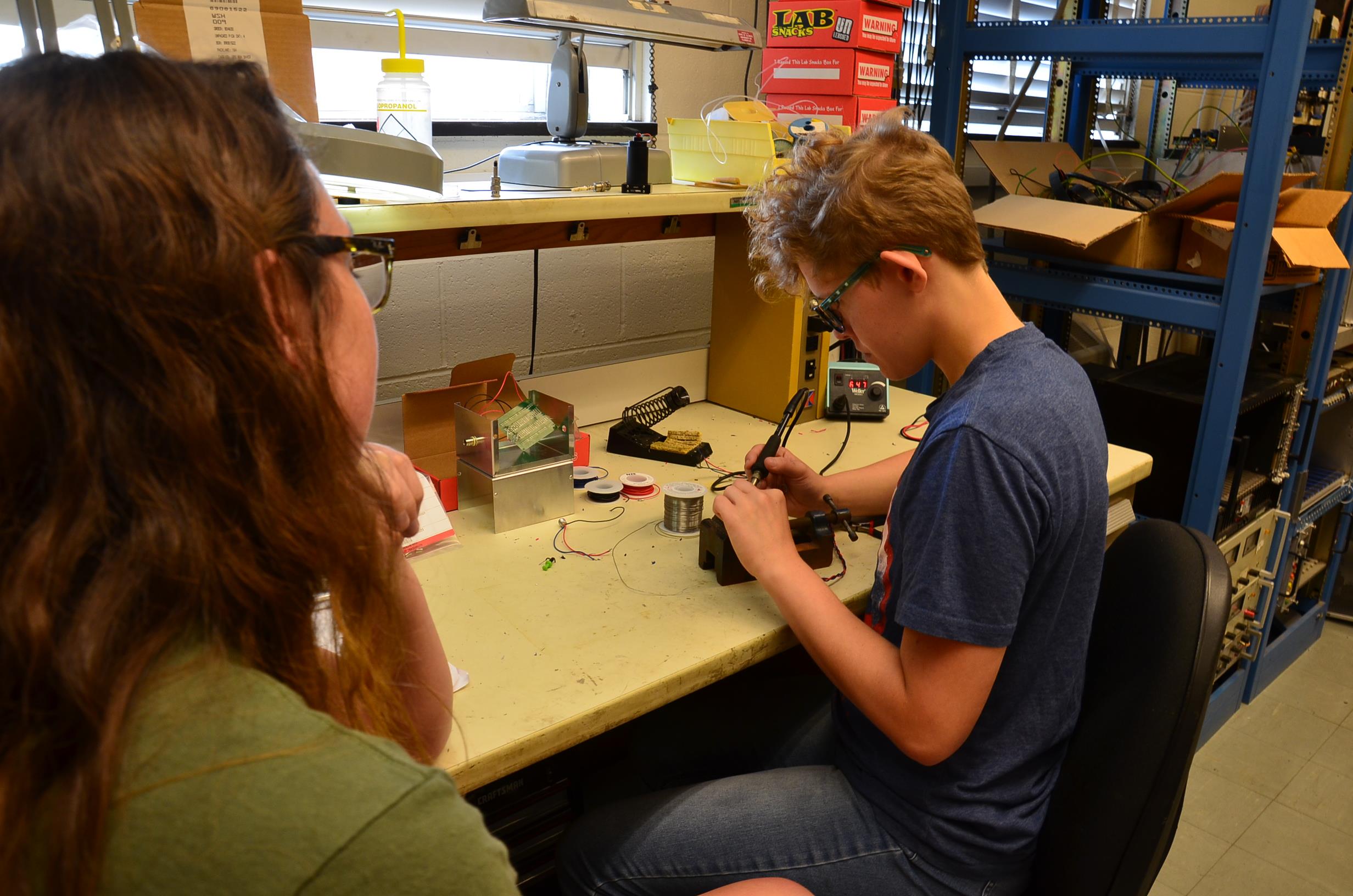 Jai Rice (right) at work with his lead mentor, Sidney Lower in Professor Doug Beck's lab. Rice worked on developing the nEDM experiment magnetometers.