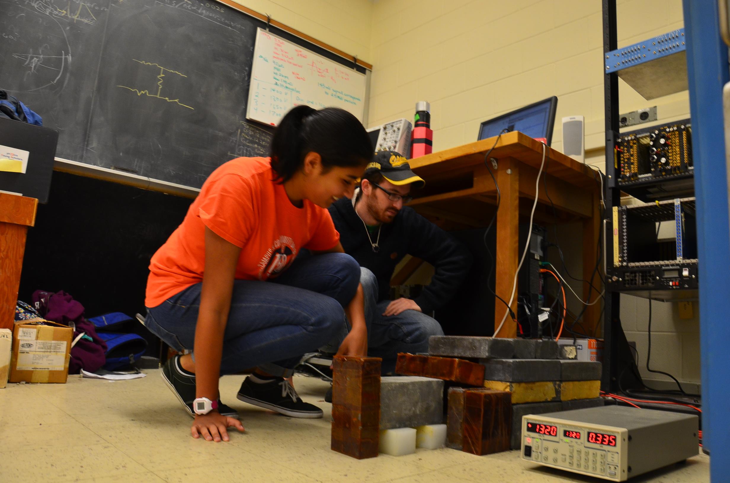 Physics Young Scholar Ritu Dave and her grad student mentor Raanan Gluck work on dark matter detectors in Professor Liang Yang's lab.