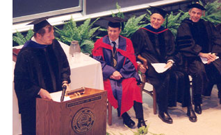 Dr. Brand Fortner speaking at the investiture of Frederick K. Lamb as the Brand and Monica Fortner Endowed Chair in Theoretical Astrophysics. From left, Dr. Fortner, Professor Lamb, Professor Miles V. Klein, Chancellor (then Provost) Richard Herman.