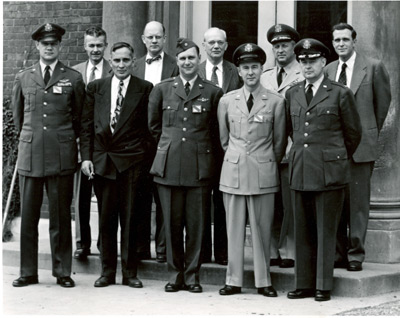 Armed Services representatives on a visit to the CSL in the 1950s. Back row, second from left, is Frederick Seitz, CSL director, standing next to F. Wheeler Loomis, Physics head. At the far right of the back row is Chalmers Sherwin, professor of physics. The photo was taken at the east entrance to the Laboratory of Physics, corner of Green and Mathews Streets.