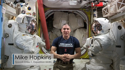 UIUC alumnus and astronaut Michael Hopkins connects to the festival from the International Space Station. Hopkins answered questions about weightlessness posed by two children participating in the &lt;em&gt;Illuminated Universe&lt;/em&gt;.