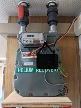A diaphragm gas meter instrumented with a raspberri pi computer measures the flow of recovered helium gas.