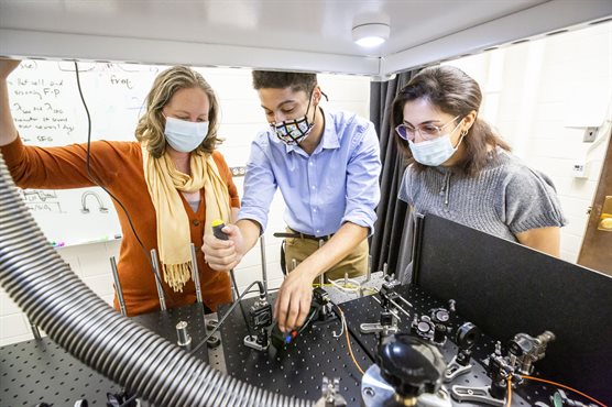 From left: Elizabeth Goldschmidt, graduate student Donny Pearson and postdoctoral fellow SafuraSharifi work on an experimental setup in Goldschmidt&rsquo;s lab at UIUC. Photo by L. Brian Stauffer, University of Illinois Urbana-Champaign
