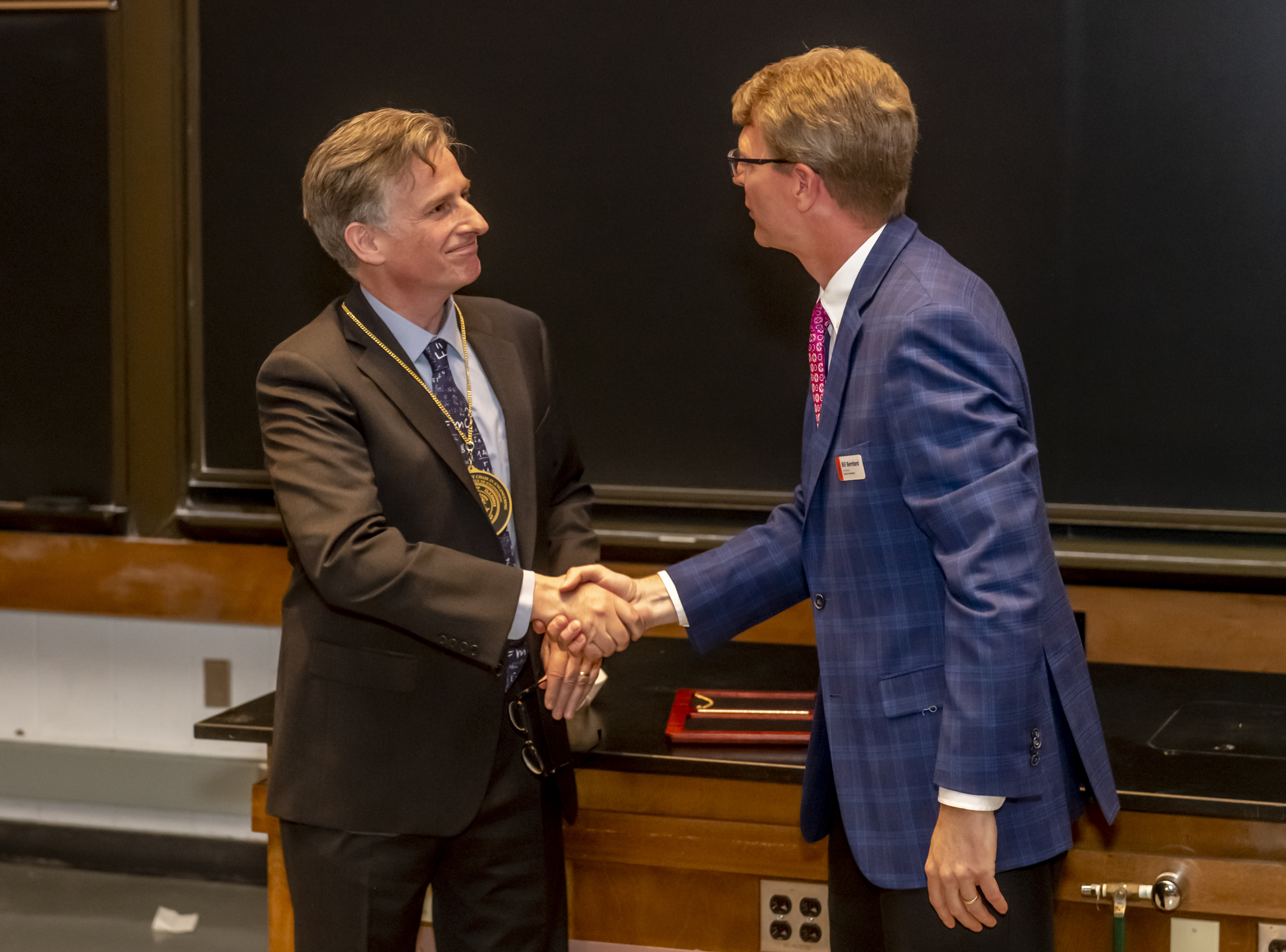 UIUC Executive Vice Provost and Professor William T. Bernhard congratulations Professor Charles Gammie on his investiture during the ceremony.