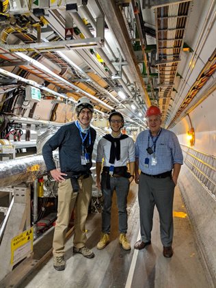 <p>UIUC scientists Riccardo Longo and Matthias Grosse Perdekamp with University of Kansas collaborator Michael Murray next to the Zero Degree Calorimeter in the LHC tunnel. The Reaction Plane Detector was designed and constructed at the Nuclear Physics Laboratory at UIUC.</p>