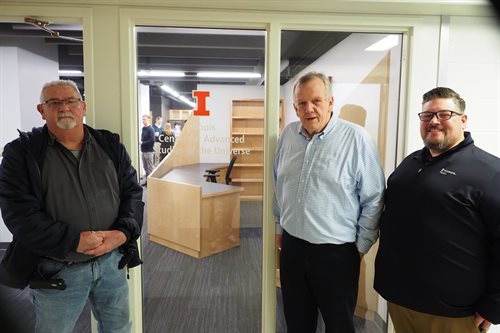 Illinois Physics Professor and Head Matthias Grosse-Perdekamp, Illinois Physics Facility Operations Coordinator Luke Prunkard, and Construction Project Coordinator Richard Dillingham pose in front of the glass doors to the new ICASU space. The front desk where a new administrative assistant will sit is visible through the glass. The block &amp;amp;amp;amp;amp;amp;amp;amp;amp;quot;I&amp;amp;amp;amp;amp;amp;amp;amp;amp;quot; and the words &amp;amp;amp;amp;amp;amp;amp;amp;amp;quot;Illinois Center for Advance Studies of the Universe&amp;amp;amp;amp;amp;amp;amp;amp;amp;quot; appear on the glass door.