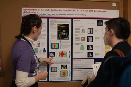 Illinois Physics student Samantha Lund presents her poster at CUWiP 2023.