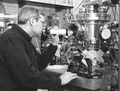 Dale Van Harlingen monitors the growth of high-temperature superconductor films in a pulsed laser ablation chamber.