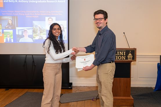 Illinois Physics undergraduate student Asmi Mauskar receives the 2024 Philip J. and Betty M. Anthony Undergraduate Research Award, presented by Associate Head for Undergraduate Programs Yann Chemla.
