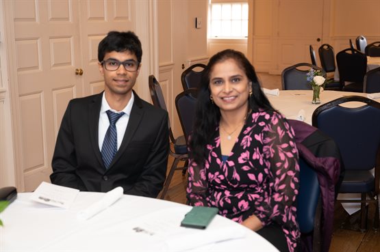Illinois Physics graduate student Apurva Narde, recipient of the 2024 Maurice Goldhaber Research Scholar Award in Nuclear Physics, sits with his guest at the Physics-on-the-Campus Luncheon.