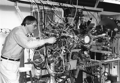 James Eckstein makes adjustments to the atomic layer-by-layer molecular beam epitaxy system in his lab.