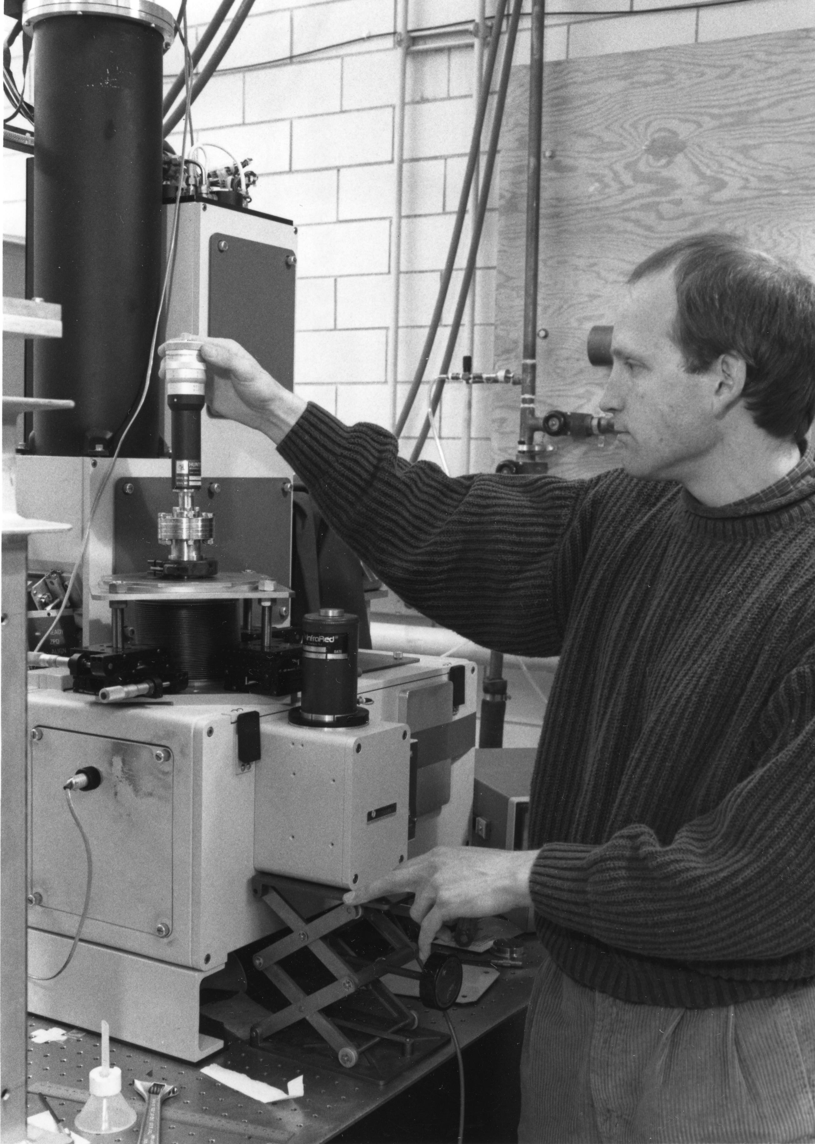 S. Lance Cooper aligns a magnetic oxide sample with his Fourier transform interferometer.