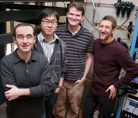 Physicists Raffi Budakian, Joonho Jang,David Ferguson, and Paul Goldbart stand in front of laboratory equipment.