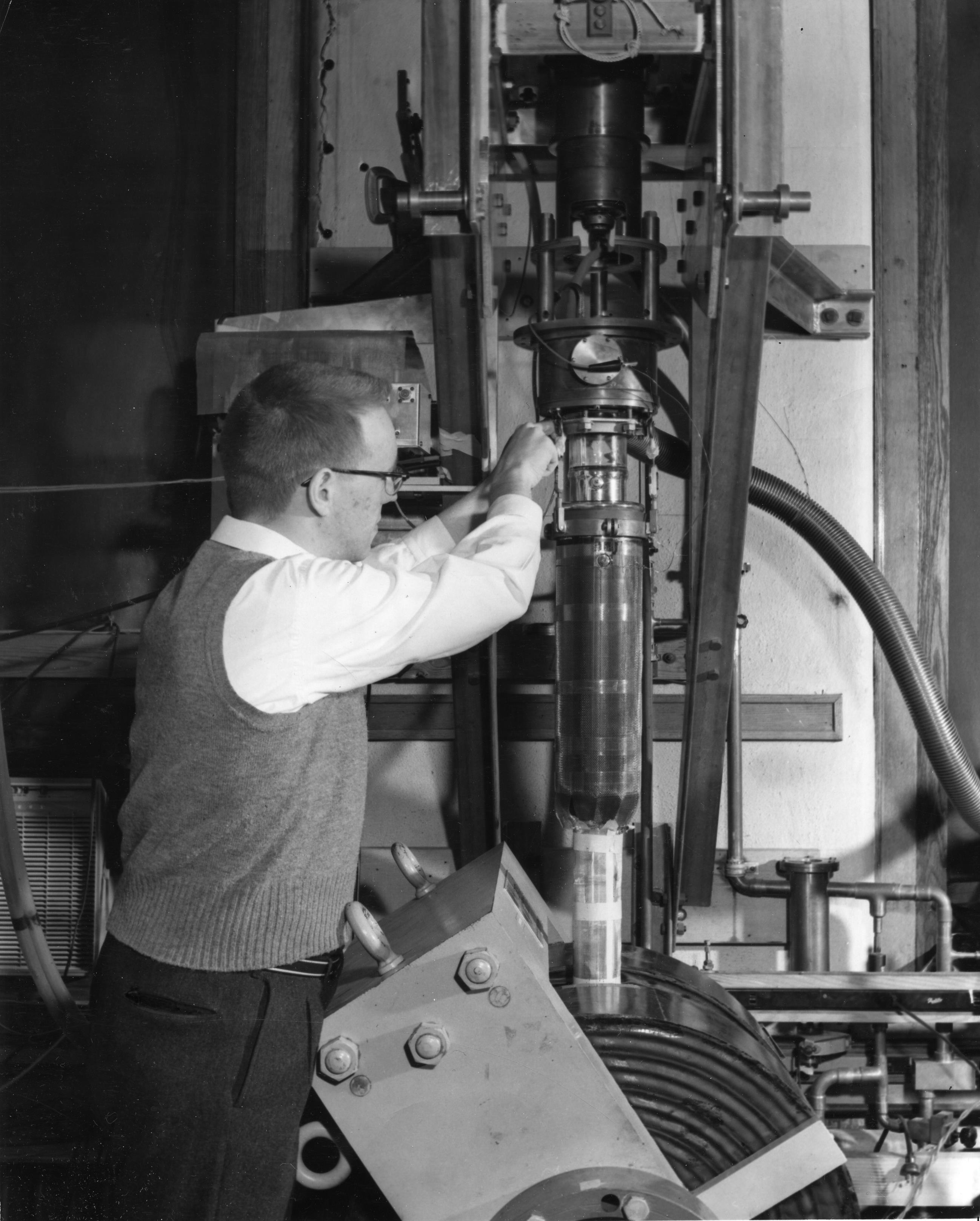 A.C. Anderson works on the cryostat in the Wheatley lab, ca. 1959.