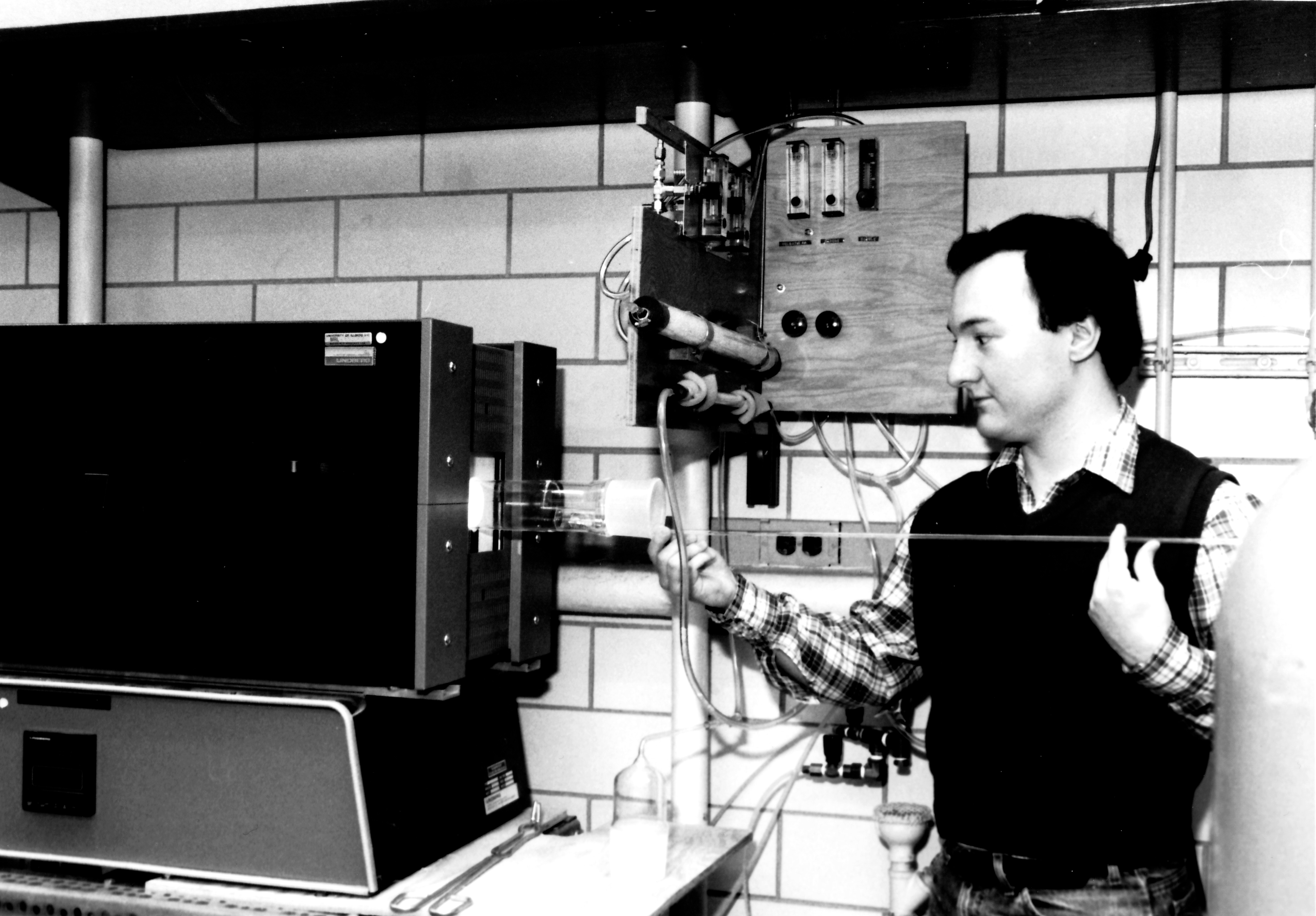 Joseph P. Rice slides a single-crystal sample into a furnace.