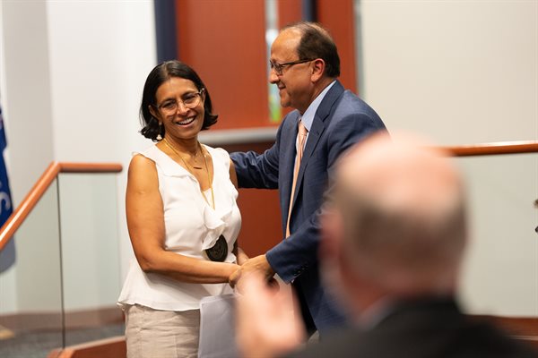 Grainger Engineering Dean and Professor Rashid Bashir (right) congratulates newly invested Donald Biggar Willett Professor in Engineering Vidya Madhavan during an investiture ceremony held October 28, 2024.